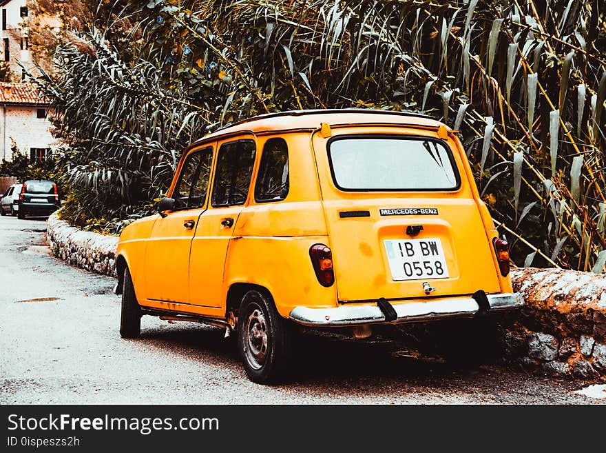 Classic Yellow Car on Side of Road at Day