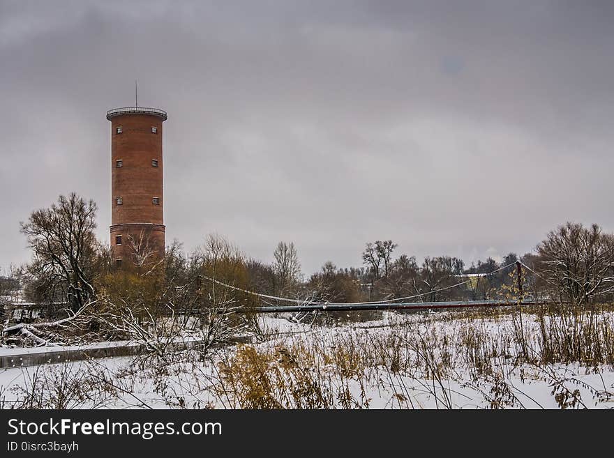 Vintage style red brick water tower of an old factory.