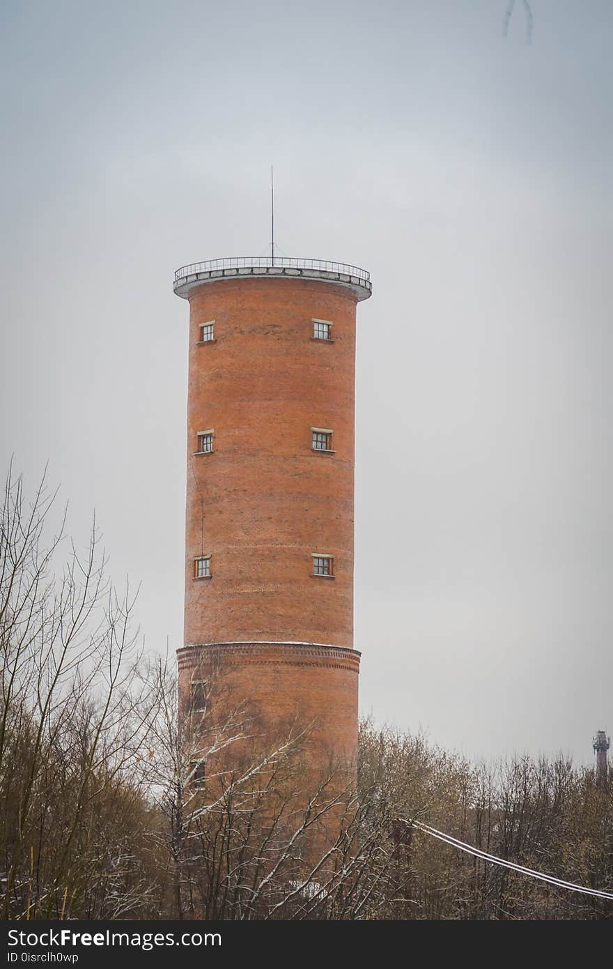 Vintage style red brick water tower of an old factory.