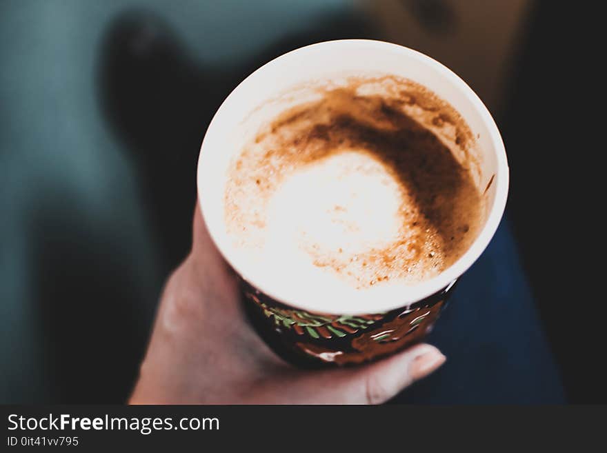 Left Hand Holding a Cup of Coffee