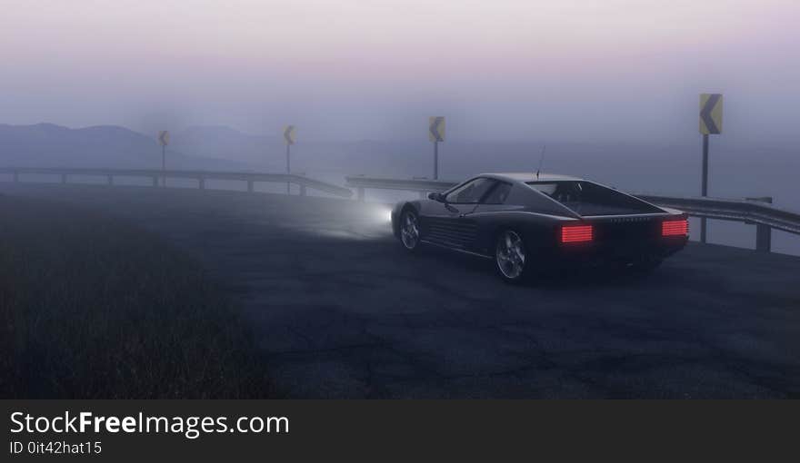 Black Coupe Parked on Concrete Road Near Body of Water