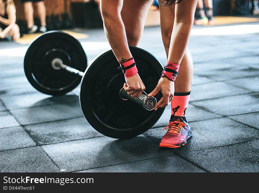 Person Holding Black Barbell