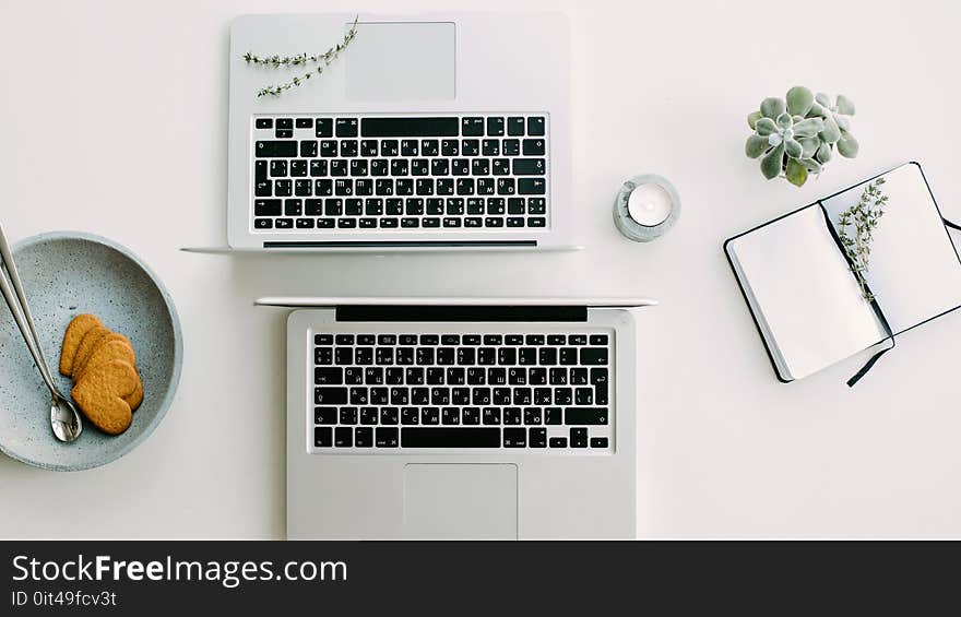 Two Macbook Pro Beside Gray Bowl