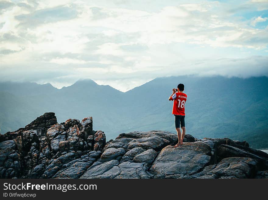 Man Having a Picture on Rock