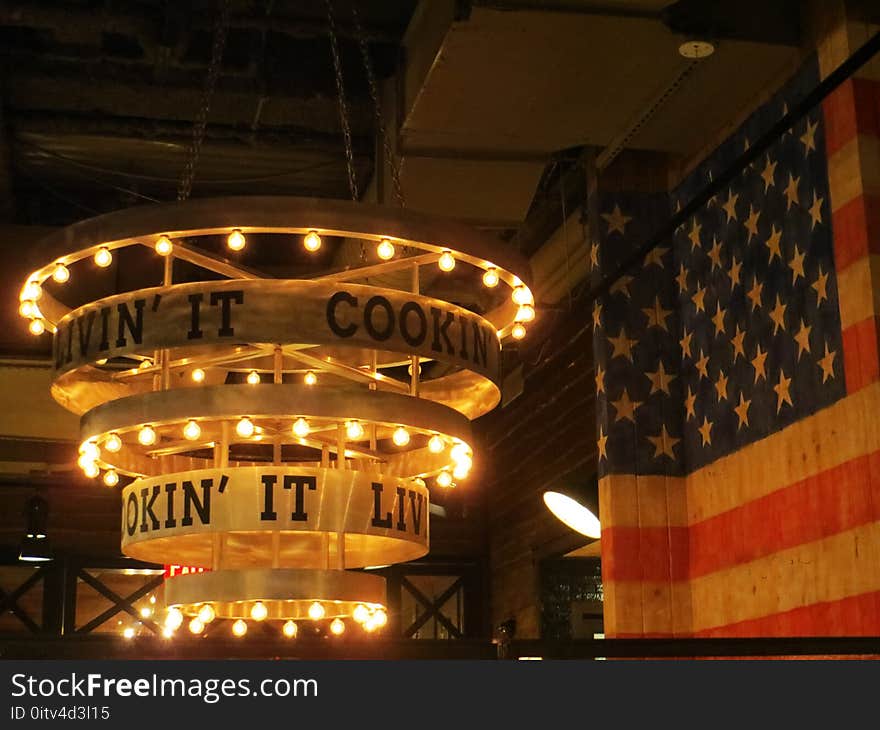 Round Beige Wooden Chandelier Near Flag of the U.s.a.