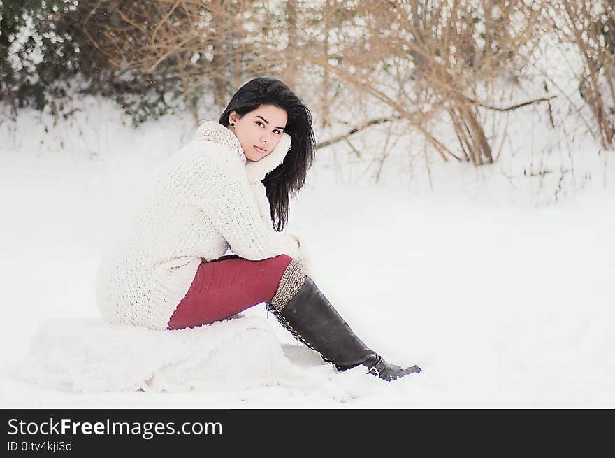 Woman In White Sweater Sitting Near Grass During Winter Season