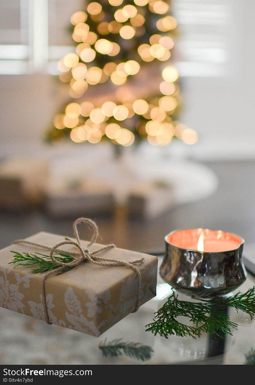 Close-Up Photography of Gift Besides Candle