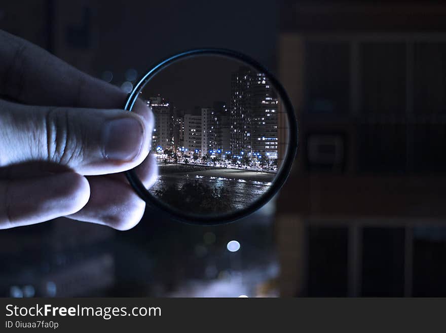 Person Holding Magnifying Glass