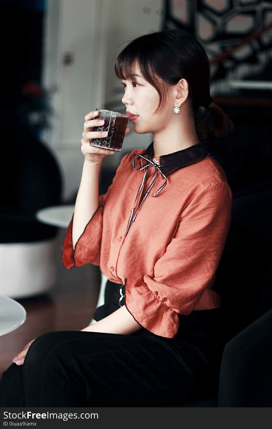 Woman in Pink and Black Dress Drinking Cola