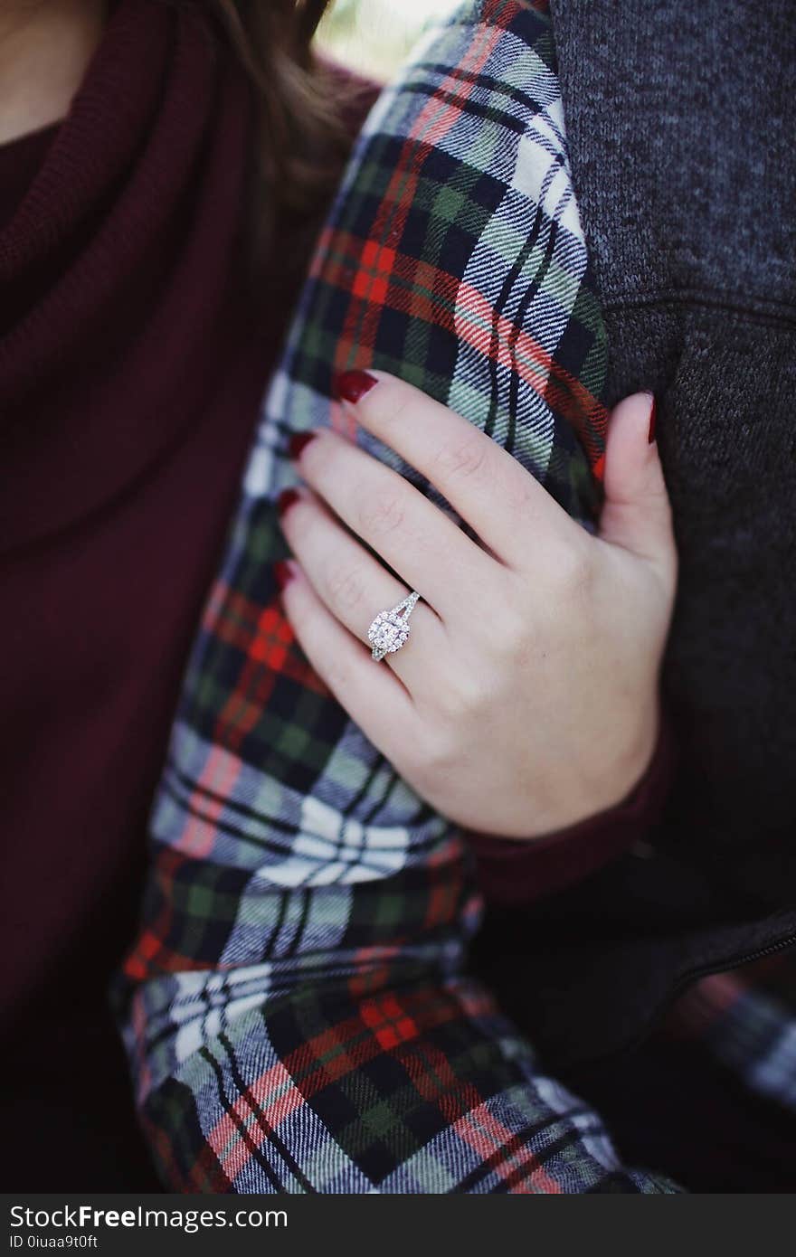 Woman Wearing Silver-colored Solitaire Ring Holding Person&#x27;s Arm