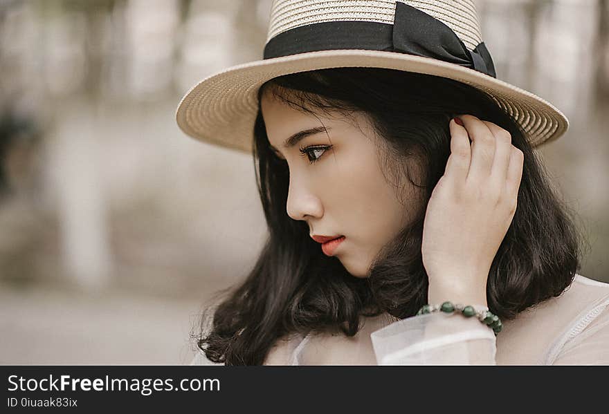 Shallow Focus Photography of Woman Wearing Brown Sun Hat