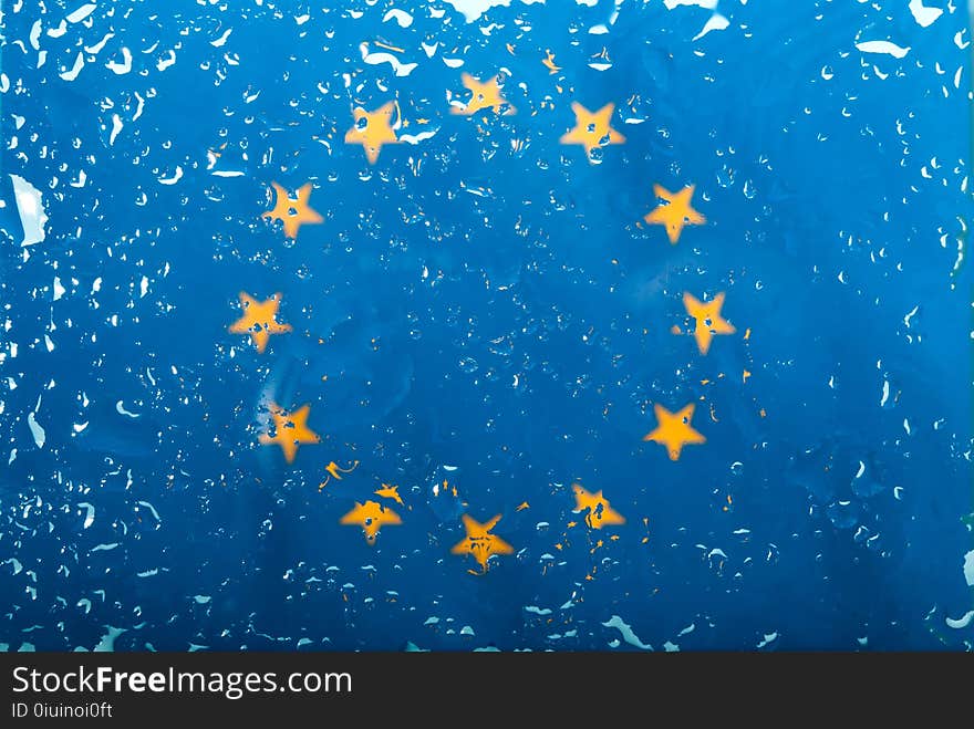 Drops of water on European Union flag background. Shallow depth of field. Selective focus. Toned. Top view. Full frame. Abstract flag pattern concept image.