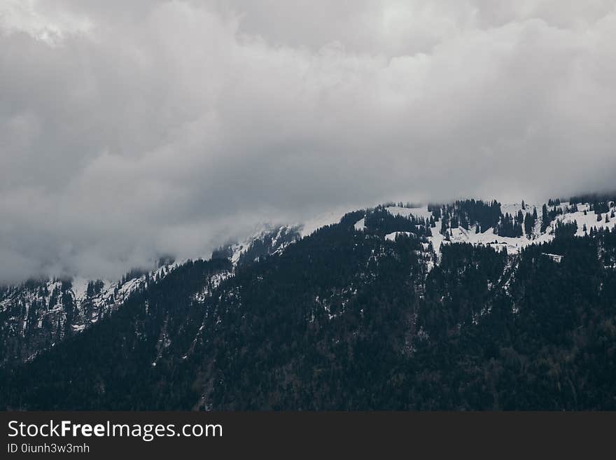 Snow-capped Mountain Under Cloudy Sky