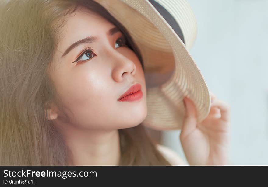 Woman Holding White Hat