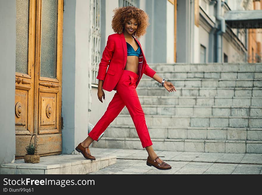 Woman Wearing Red Suit and Pants Outfit