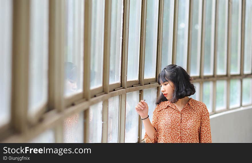 Black Haired Woman Wearing Brown and Yellow Dress Shirt