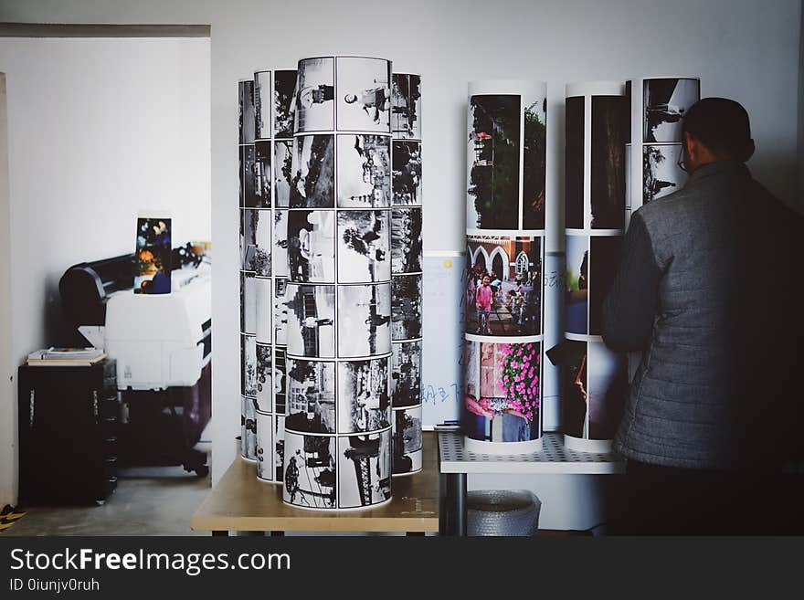 Man Standing in Front of Photo Stands