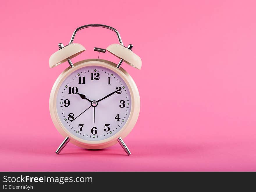 Old clock with alarm isolated on pink background with space for text