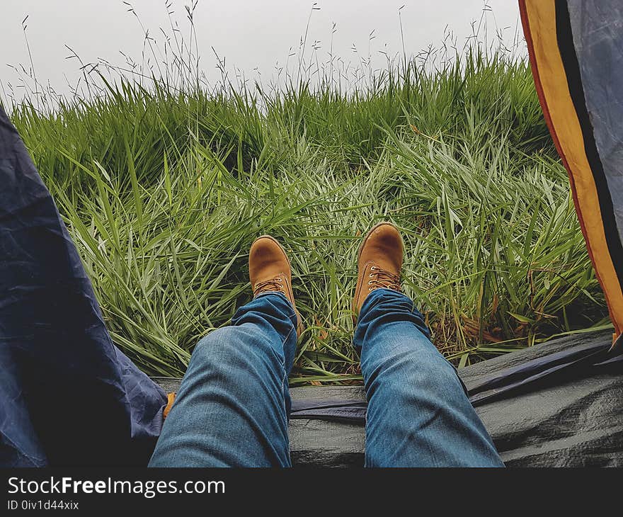 Photo of Man in Blue Jeans and Work Boots