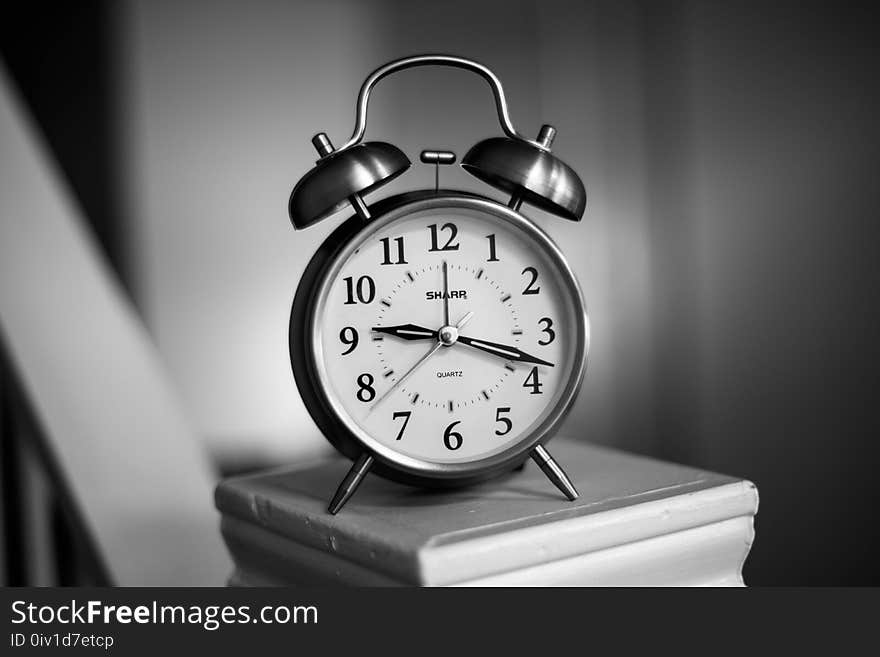 Grayscale Photo of Twin Bell Alarm Clock