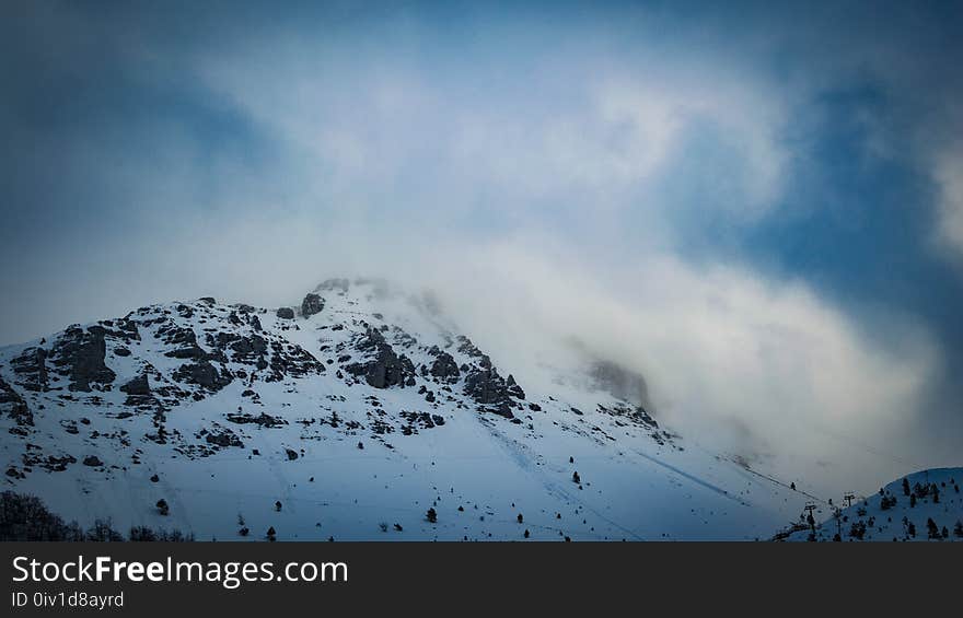 Snow Covered Mountain Under Cloudy Blue Sky