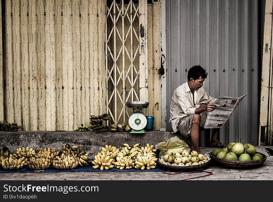 Man Sitting Near Fruits