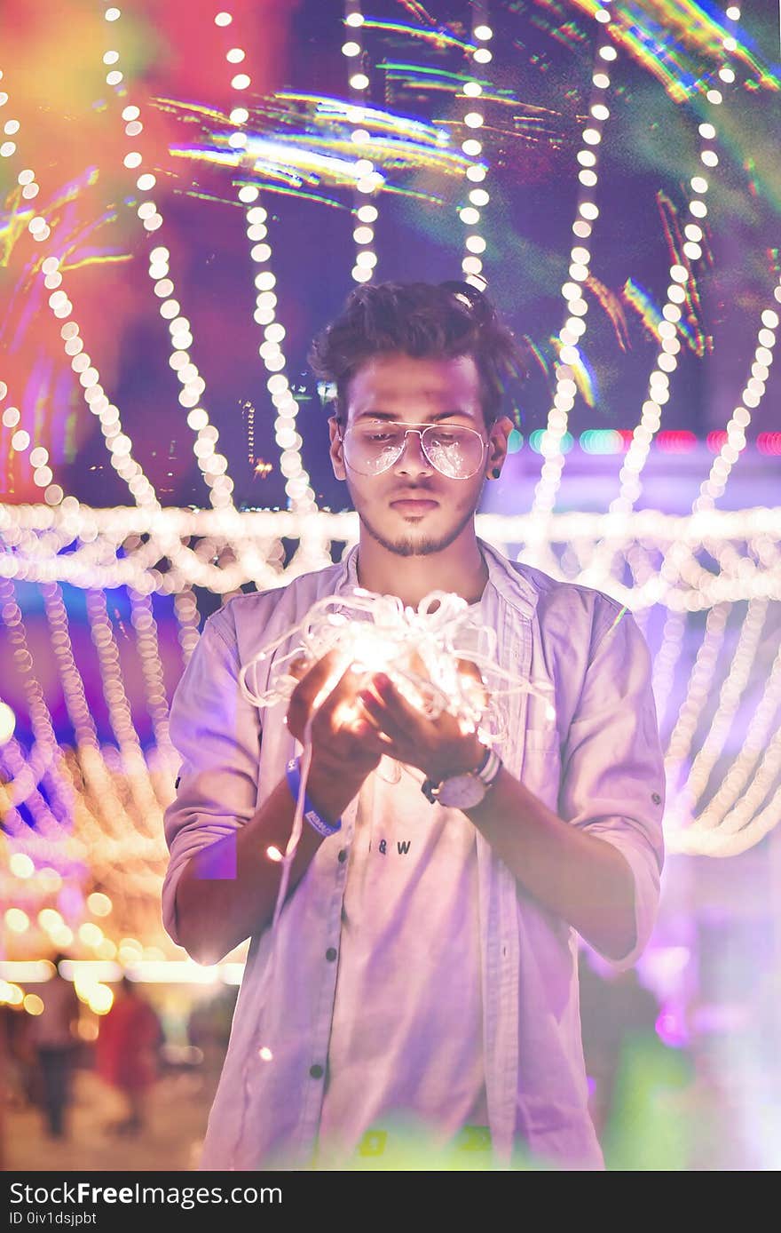 Man Holding String Light during Nighttime