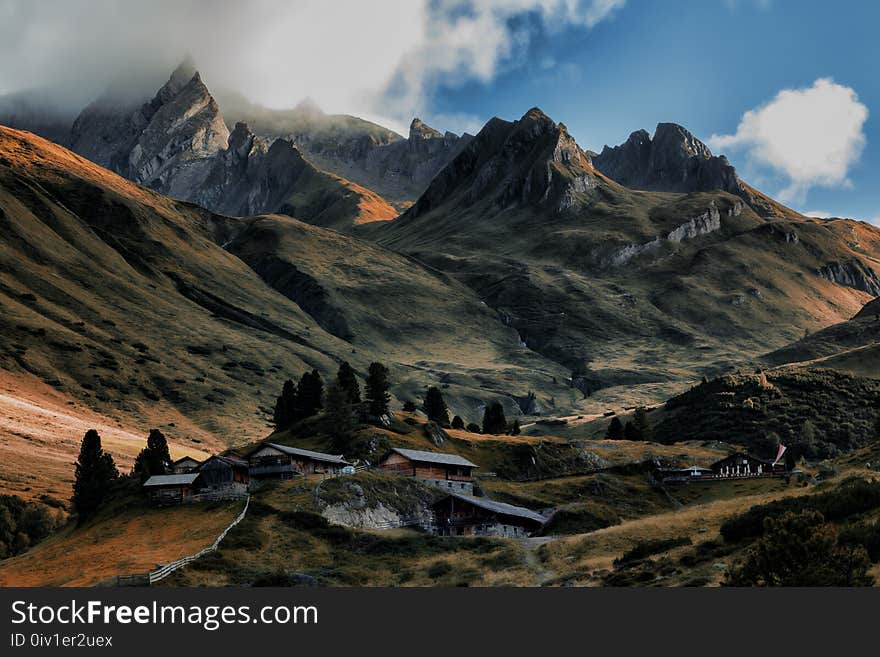 Brown House in Between of Mountains