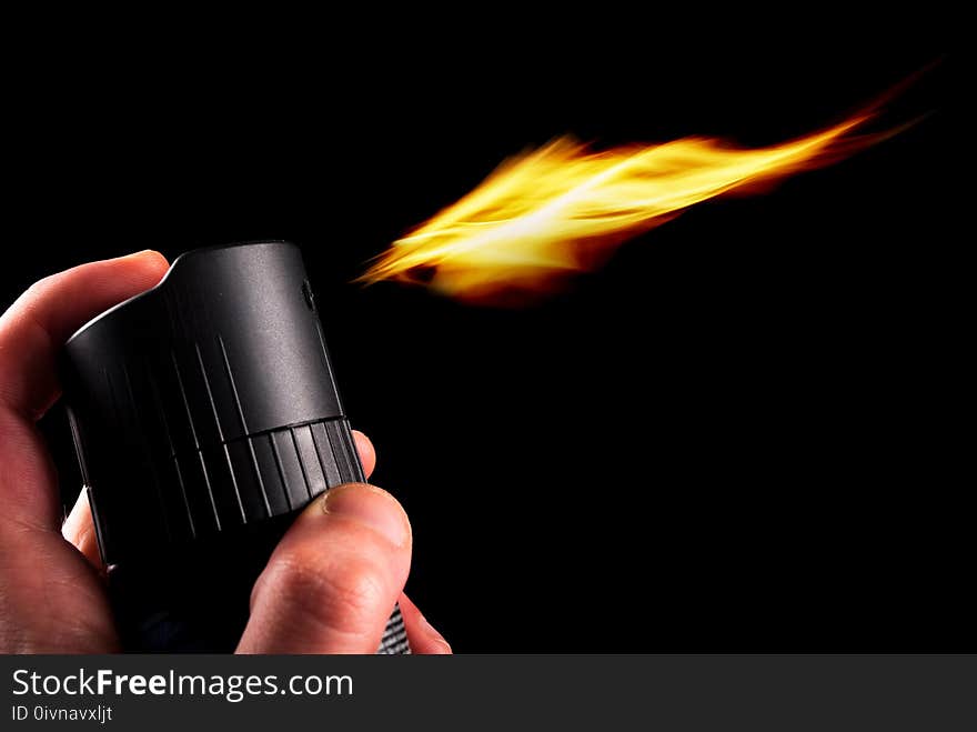 Deodorant can and fire blazing out of bottle isolated on black background. Close up