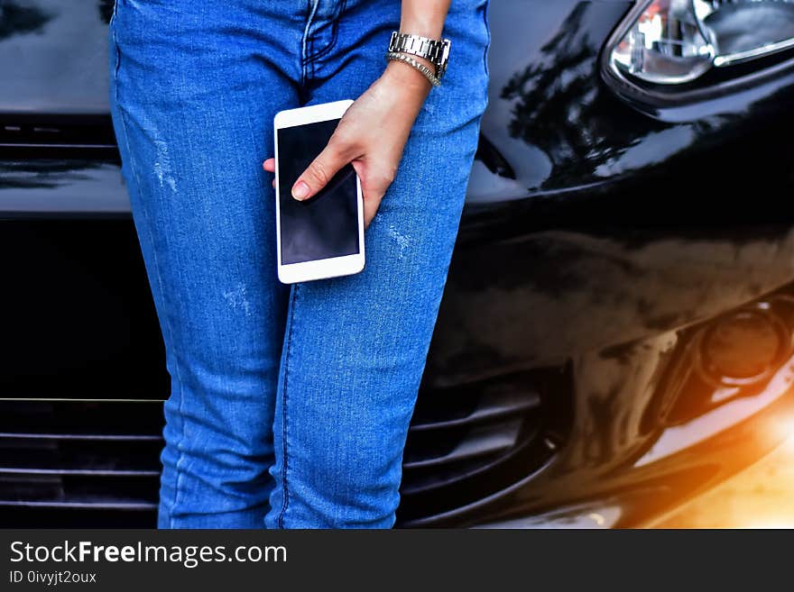 Women are using mobile phones to buy online, play games, social media and entertainment at the car. Women are using mobile phones to buy online, play games, social media and entertainment at the car.