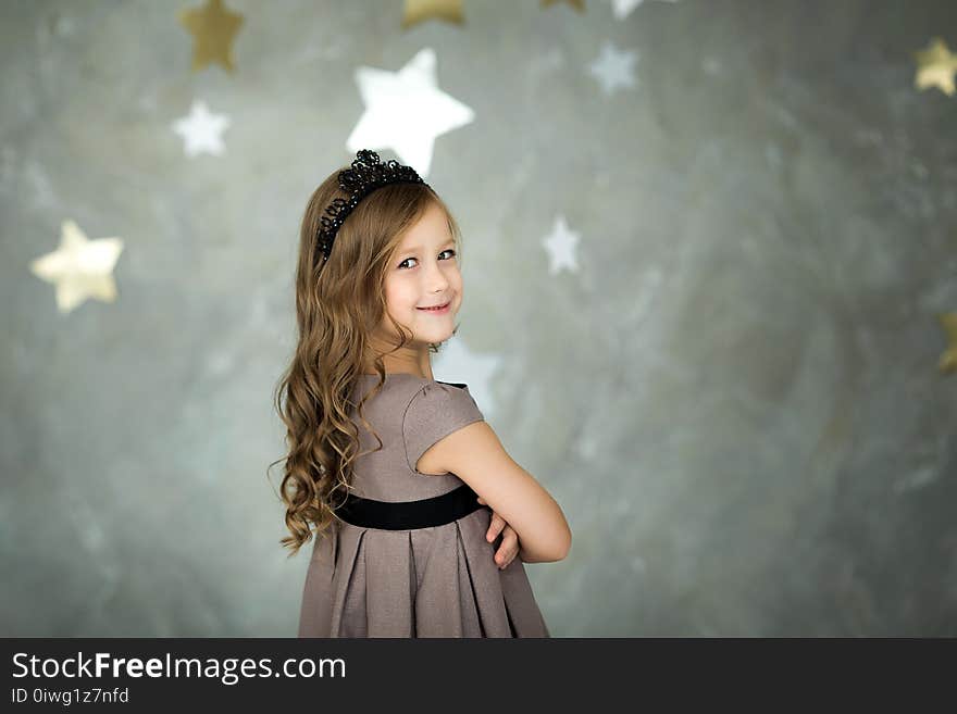 Portrait of a happy little girl on a background of stars