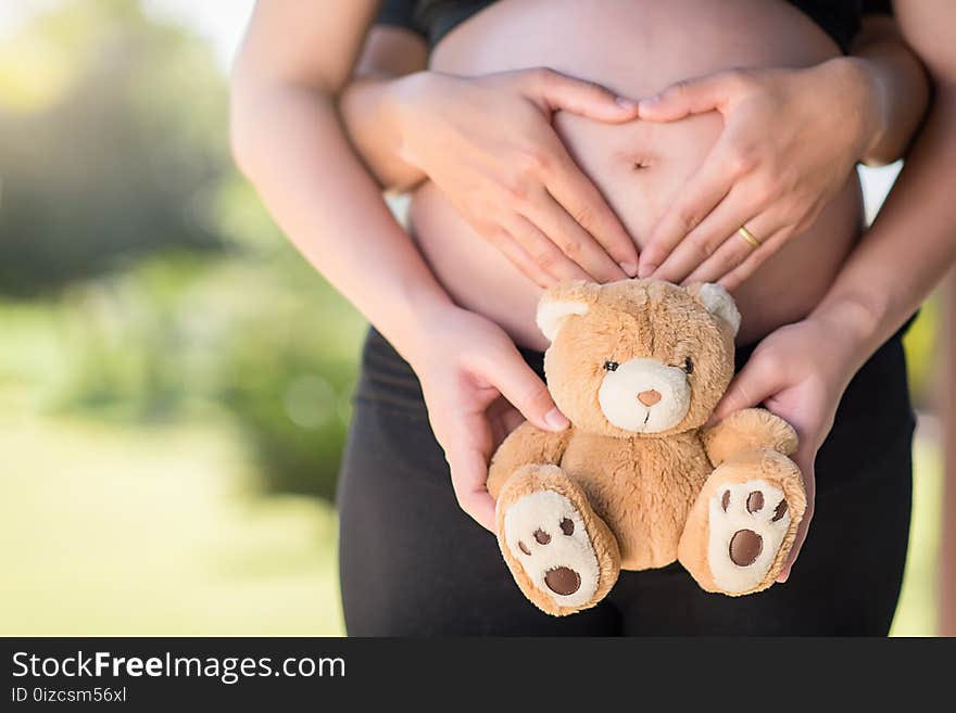 Pregnant woman with teddy bear