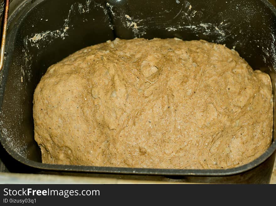 A tasty loaf of bread baked in a house bread maker close up. A tasty loaf of bread baked in a house bread maker close up.