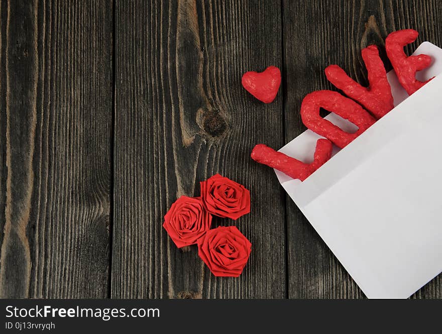 Word LOVE on wooden background. Concept of Valentine`s Day.