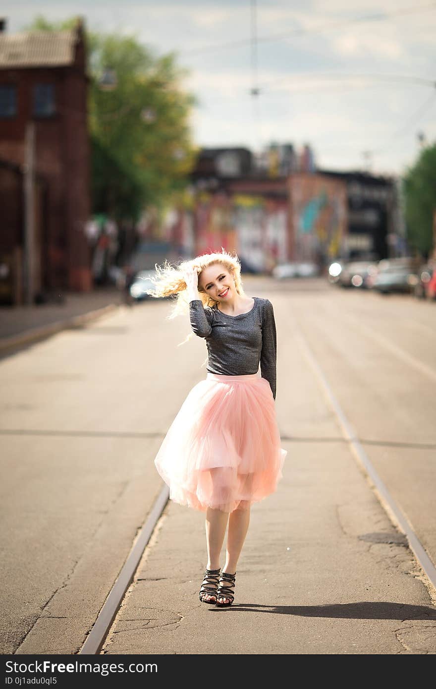 Portrait in full growth, young beautiful woman walking on the street, summer outdoors