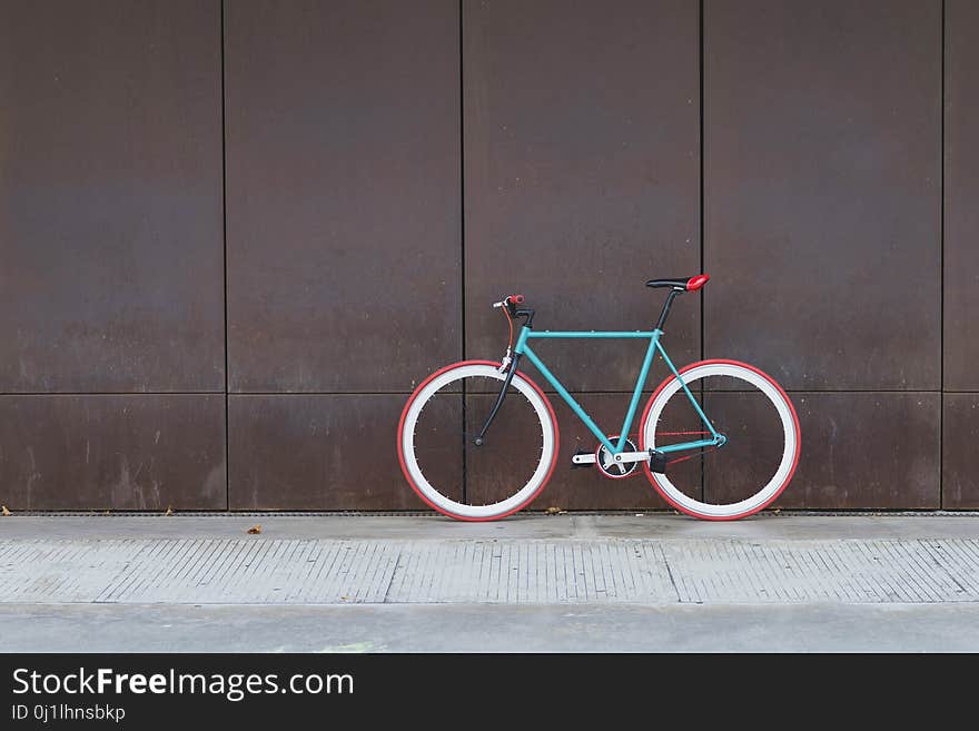 A City bicycle fixed gear on a brown wall