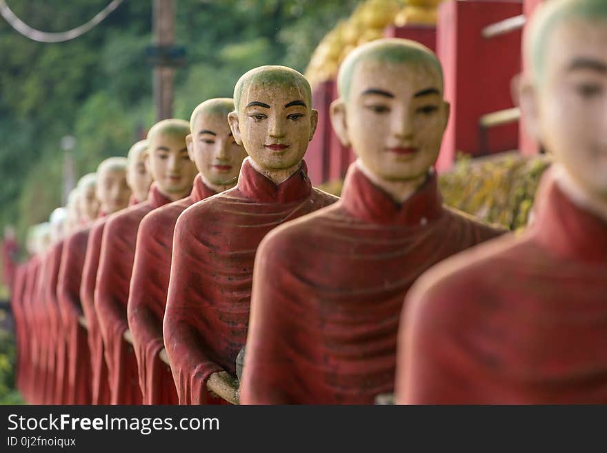 Buddhist monks stone statues row at Kaw Ka Thaung cave