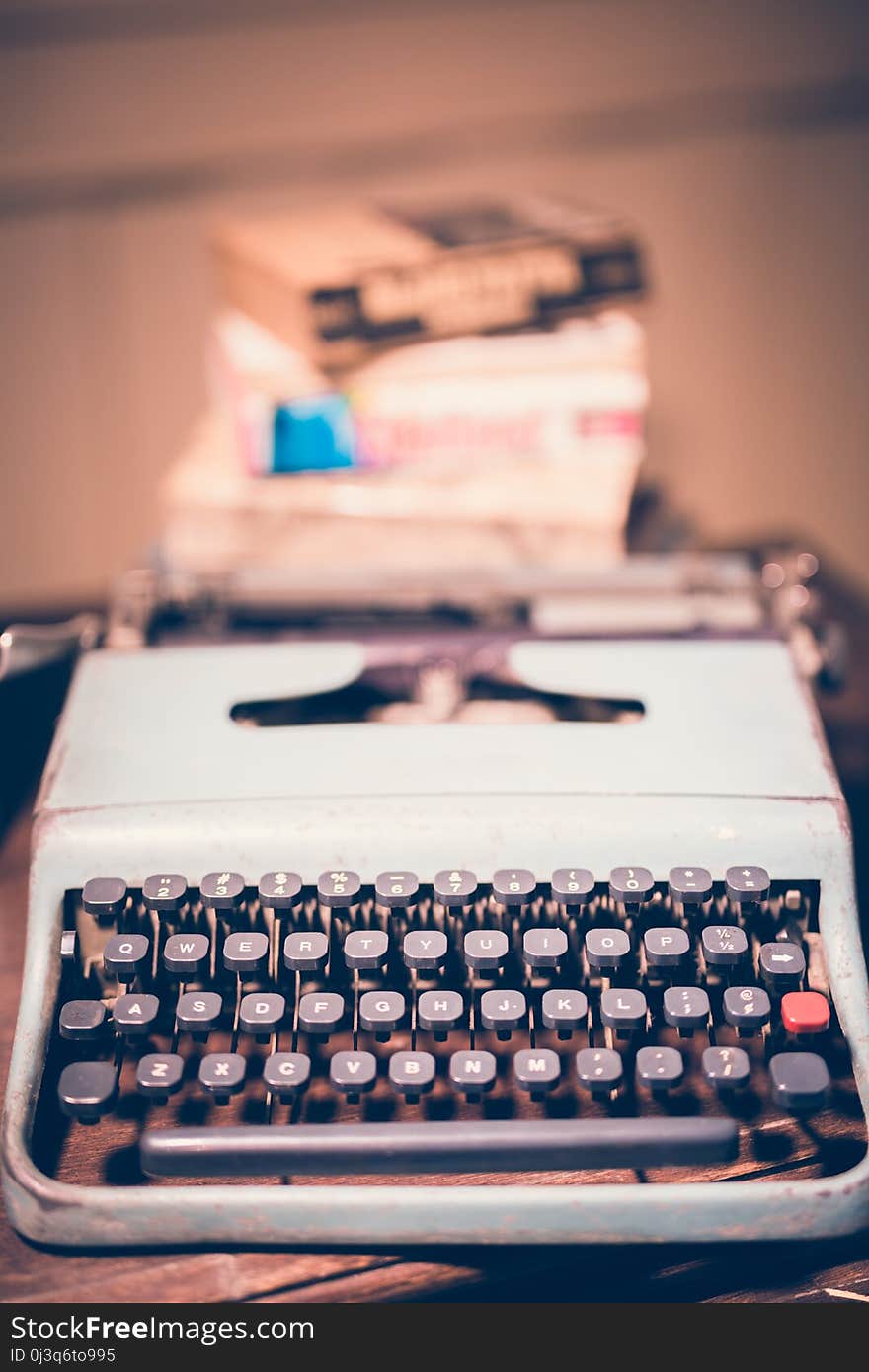 Typewriter antique vintage style with old documents or old letter and books for writer on wooden desk zoom in front view of typewriter writer or editor in vintage office concept.