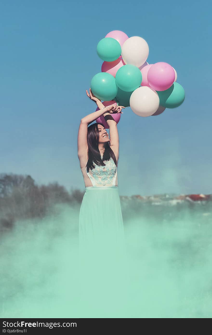 Woman Wearing Green Dress Holding Balloons