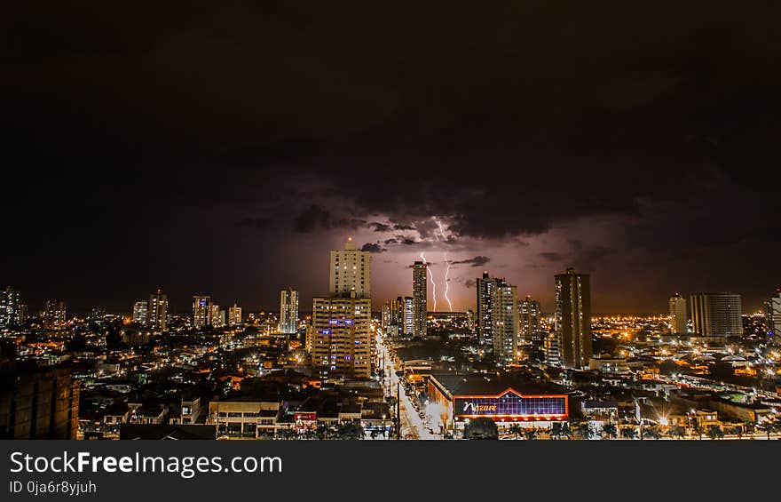 Thunderstorms Above City during Night Time