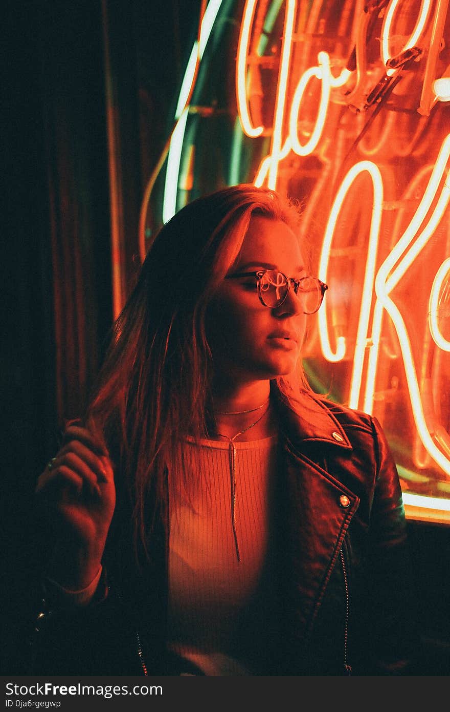 Woman in Denim Jacket Near Neon Signage