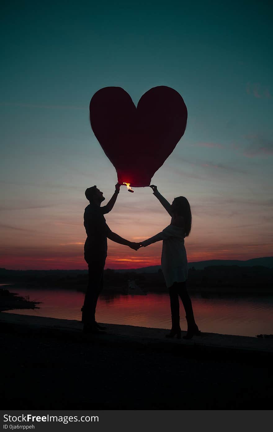 Silhouette Photo Of Man And Woman Holding Heart Lantern