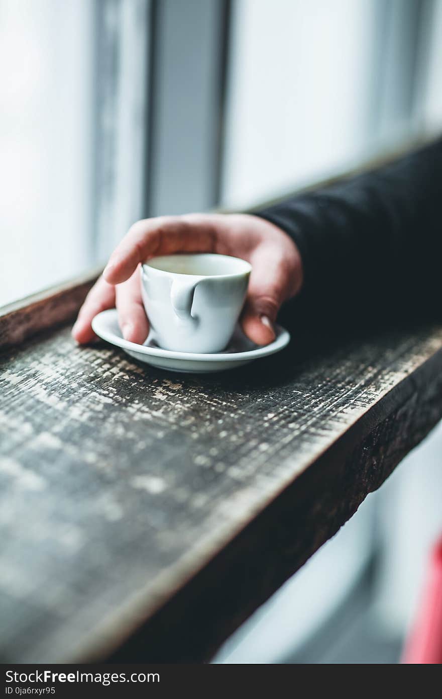 Person Holding White Teacup