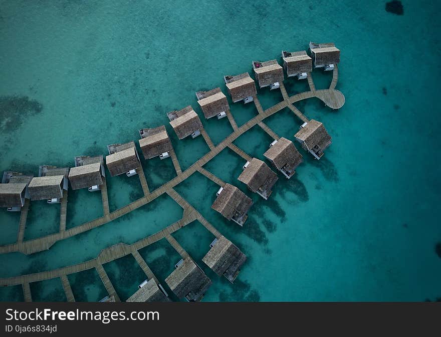 Top View Photo Of Cabin On Body Of Water