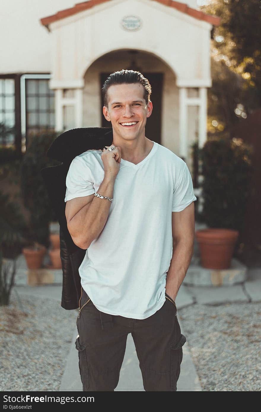 Man in White V-neck T-shirt and Black Pants