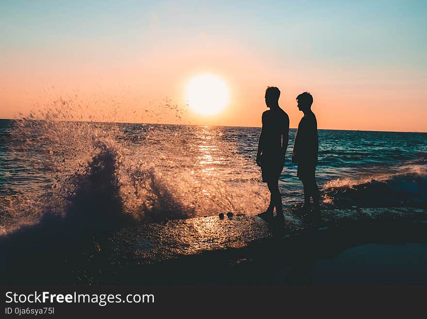 Two Men Standing on Seashore