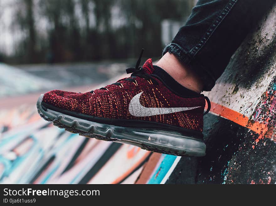 Close-Up Photography of Red and Black Nike Running Shoe