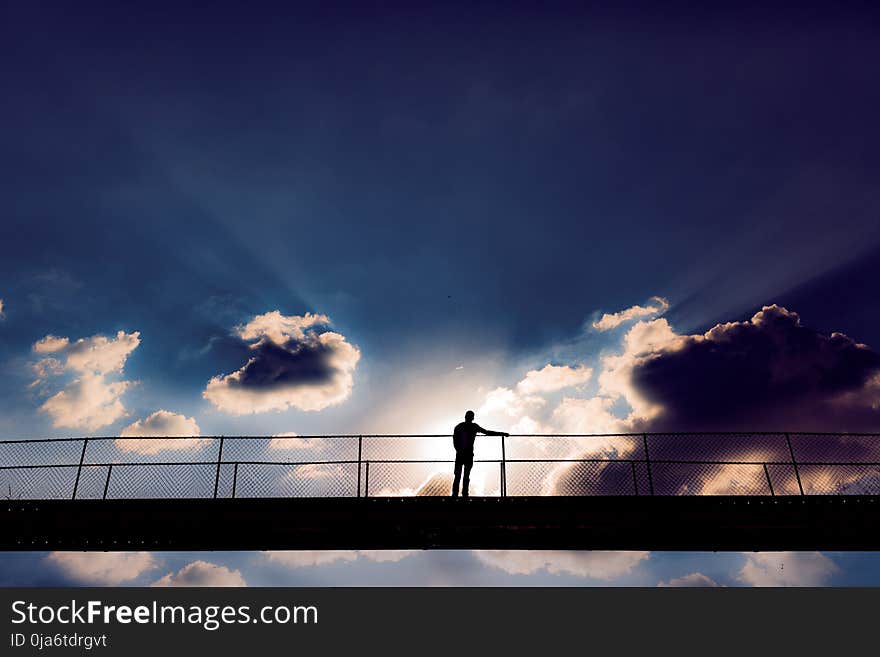 Man In The Middle Of A Bridge