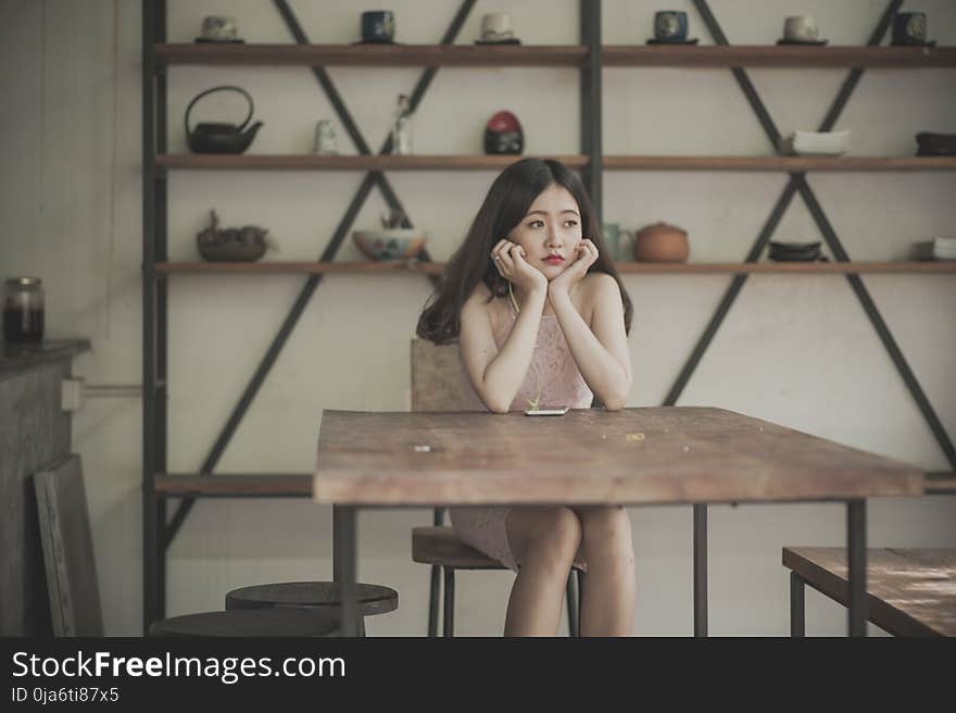 Photography of a Woman Sitting on The Chair Listening to Music