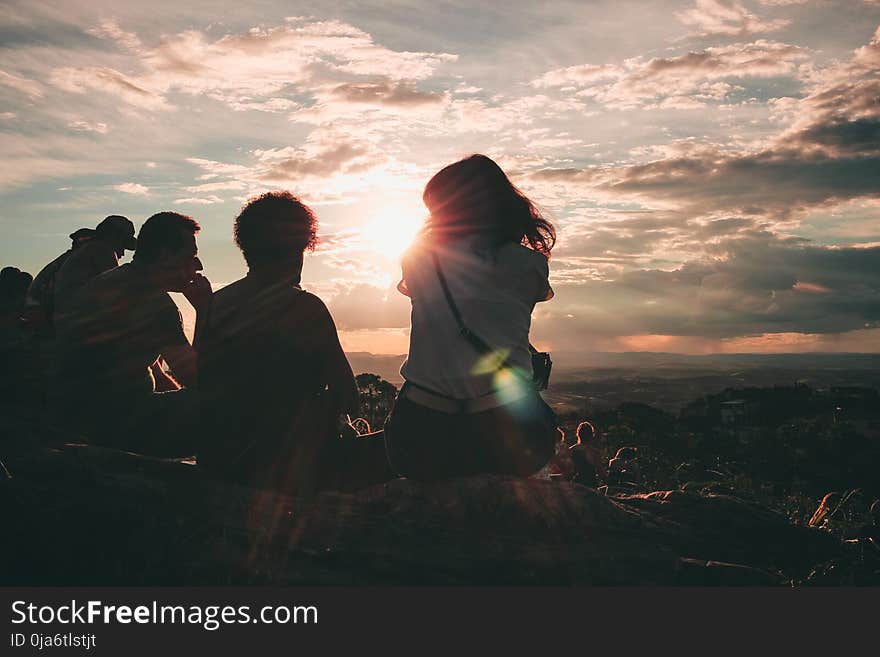 Group of People Sitting on Hill